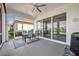 The porch has a seating area with sliding glass doors and views of the backyard at 585 Mosaic Blvd, Daytona Beach, FL 32124