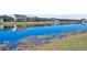 Scenic waterfront view showcasing calm water reflecting the surrounding homes and clear blue sky at 585 Mosaic Blvd, Daytona Beach, FL 32124