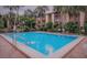 Inviting community pool surrounded by lush tropical foliage and swaying palm trees at 592 Orange Dr # 140, Altamonte Springs, FL 32701