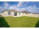 Wide open backyard featuring sliding glass door to the home interior and full privacy fence at 650 Peyton Brooke Way, Winter Haven, FL 33881