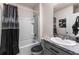 Well-lit bathroom with a shower/tub combination, vanity, and dark decorative accents at 650 Peyton Brooke Way, Winter Haven, FL 33881