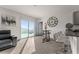 Bright living room with a sliding glass door, modern furniture, and adjacent bar seating area at 650 Peyton Brooke Way, Winter Haven, FL 33881