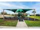 Community playground with shade cover, benches, and lush landscaping at 650 Peyton Brooke Way, Winter Haven, FL 33881