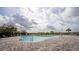 Community pool with ample seating, shade umbrellas, and paved pool deck at 650 Peyton Brooke Way, Winter Haven, FL 33881