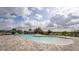 Community pool with ample seating, shade umbrellas, and paved pool deck at 650 Peyton Brooke Way, Winter Haven, FL 33881