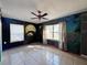 Bedroom featuring custom-painted walls, tile floors, and a ceiling fan at 7002 Rose Ave, Orlando, FL 32810