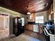 Kitchen area with essential appliances, tile flooring, and a view into the adjacent living area at 7002 Rose Ave, Orlando, FL 32810