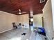 Living room featuring tile floors, a ceiling fan, and a view into the adjacent kitchen at 7002 Rose Ave, Orlando, FL 32810