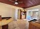 Room with tiled floor, wooden ceiling, desk, hutch and view into side yard at 7002 Rose Ave, Orlando, FL 32810