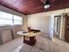 Room with tiled floor, wooden ceiling, desk and view into side yard at 7002 Rose Ave, Orlando, FL 32810