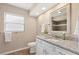 Bathroom showcasing a single vanity with granite countertops and a shower reflected in the mirror at 7037 Edgeworth Dr, Orlando, FL 32819