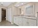 Bathroom showcasing a double vanity with granite countertops and a tiled floor at 7037 Edgeworth Dr, Orlando, FL 32819