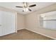 Bedroom featuring wood-look flooring, a ceiling fan, and a sliding closet door at 7037 Edgeworth Dr, Orlando, FL 32819