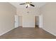 Spacious bedroom featuring wood-look flooring, a ceiling fan, and ample natural light at 7037 Edgeworth Dr, Orlando, FL 32819