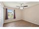 Bedroom featuring wood-look flooring, a ceiling fan, and a window with curtains at 7037 Edgeworth Dr, Orlando, FL 32819