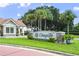 Entrance to the Orange Tree community with lush landscaping and an inviting gatehouse at 7037 Edgeworth Dr, Orlando, FL 32819