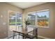 Cozy dining area with a view of the screened-in pool and patio through large windows and sliding glass door at 7037 Edgeworth Dr, Orlando, FL 32819