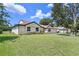 A well-maintained home with a lush green lawn, offering a glimpse of comfortable suburban living at 7037 Edgeworth Dr, Orlando, FL 32819