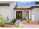 Charming entryway with double doors and manicured landscaping at 7037 Edgeworth Dr, Orlando, FL 32819