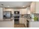 Well-lit kitchen with stainless steel appliances, granite counters, breakfast bar and tiled backsplash at 7037 Edgeworth Dr, Orlando, FL 32819