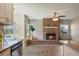 Living room featuring a brick fireplace and wood-look tile flooring at 7037 Edgeworth Dr, Orlando, FL 32819