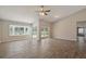 Large living room with tile floors, ceiling fan and sliding glass doors at 7037 Edgeworth Dr, Orlando, FL 32819