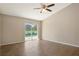 Open living space with a sliding door to a screened-in patio and pool area, featuring wood-look tile flooring at 7037 Edgeworth Dr, Orlando, FL 32819