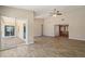 Open living room with tile floors, ceiling fan and sliding glass doors at 7037 Edgeworth Dr, Orlando, FL 32819