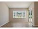 Bright living room showcasing a bay window and sliding door that leads to a screened-in patio with a pool view at 7037 Edgeworth Dr, Orlando, FL 32819