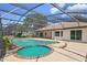 Backyard pool area featuring a spa and screened-in enclosure, ideal for relaxation at 7037 Edgeworth Dr, Orlando, FL 32819