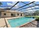 Screened-in pool with spa and a beautiful view from the backyard at 7037 Edgeworth Dr, Orlando, FL 32819