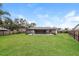 Expansive backyard featuring a caged pool, a large manicured lawn, and mature landscaping at 7215 Scenic Pl, Lakeland, FL 33810