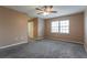 Neutral bedroom featuring carpeted floors, ceiling fan, and a window for natural light at 7215 Scenic Pl, Lakeland, FL 33810