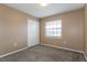 Carpeted bedroom featuring a window for natural light and a double door closet for ample storage at 7215 Scenic Pl, Lakeland, FL 33810