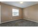 Cozy carpeted bedroom featuring neutral walls, a window for natural light, and ample space at 7215 Scenic Pl, Lakeland, FL 33810