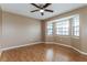 Serene bedroom with natural light from bay window, featuring neutral tones and wood floors at 7215 Scenic Pl, Lakeland, FL 33810