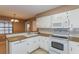 Bright kitchen featuring white appliances, ample counter space, and tile flooring at 7215 Scenic Pl, Lakeland, FL 33810