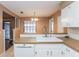 Updated kitchen featuring a large sink, white cabinets, and stylish tile backsplash at 7215 Scenic Pl, Lakeland, FL 33810