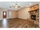 Inviting living room with vaulted ceiling, stone fireplace, and stylish wood-look floors at 7215 Scenic Pl, Lakeland, FL 33810