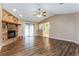 Bright living room boasts wood floors, stone fireplace, and sliding door access to outdoor area at 7215 Scenic Pl, Lakeland, FL 33810