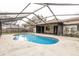 Backyard featuring a caged in pool with a concrete patio area surrounded by mature landscaping at 7215 Scenic Pl, Lakeland, FL 33810