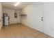 Unfinished storage room with tile flooring, a shelving unit, and a water heater at 7215 Scenic Pl, Lakeland, FL 33810