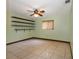 Bright bedroom with neutral tile flooring, a ceiling fan, and ample shelving at 7252 June Bug Ln, Orlando, FL 32818