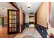 Hallway with decorative tile flooring and paneled wood accents, leading to other rooms at 7252 June Bug Ln, Orlando, FL 32818