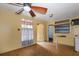 A shot of a yellow interior, showing a ceiling fan, floors, window and a partial countertop at 7252 June Bug Ln, Orlando, FL 32818