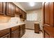 Kitchen with wooden cabinets, a white tiled backsplash, and classic tiled floor at 7252 June Bug Ln, Orlando, FL 32818