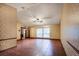 Open living room with tile flooring, a ceiling fan, and natural light at 7252 June Bug Ln, Orlando, FL 32818