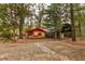 Exterior shot of a yellow shed with red trim and a covered front porch and concrete pad at 7252 June Bug Ln, Orlando, FL 32818