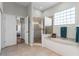 Bright bathroom featuring a glass enclosed shower, bathtub and earth-toned tile at 739 Spring Island Way, Orlando, FL 32828