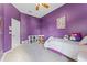 purple bedroom features wall decor, white carpet and a ceiling fan at 739 Spring Island Way, Orlando, FL 32828